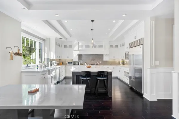 a large kitchen with a table and chairs