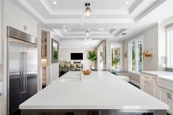 a large kitchen with a large counter top appliances and stainless steel appliances