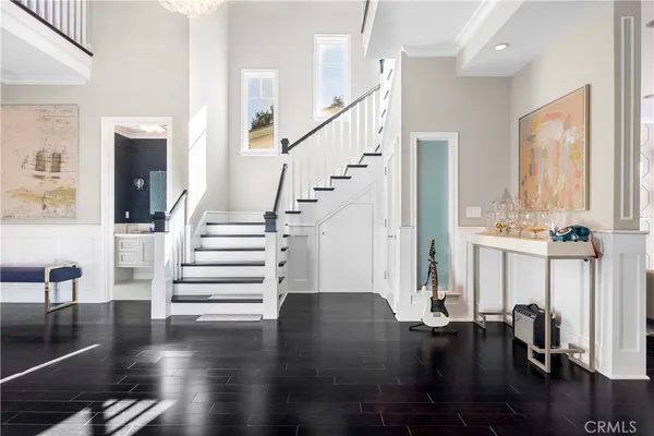 a view of entryway and hall with wooden floor