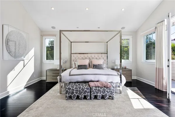 a bedroom with a large bed and a window
