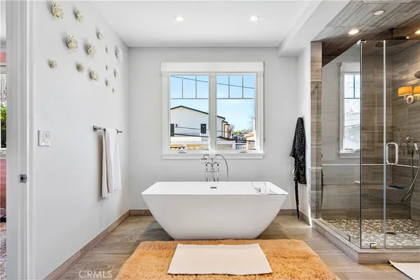 a spacious bathroom with a bathtub and shower