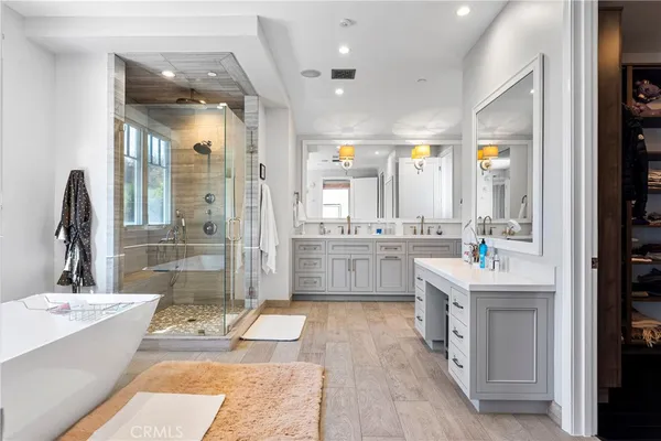 a bathroom with a double vanity sink a mirror and a shower