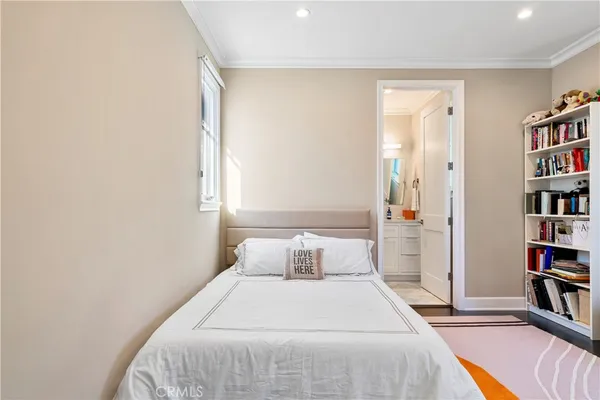 a bedroom with a bed and a book shelf