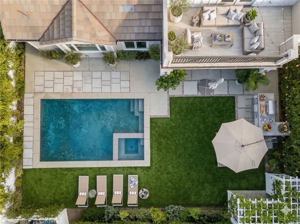 a view of a white house with a yard and table and chairs