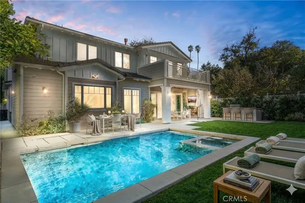 a view of a house with backyard porch and sitting area