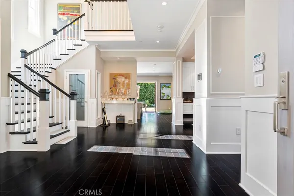 a view of entryway and hall with wooden floor