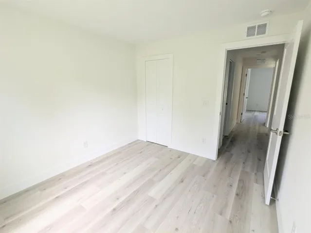 a view of hallway with wooden floor