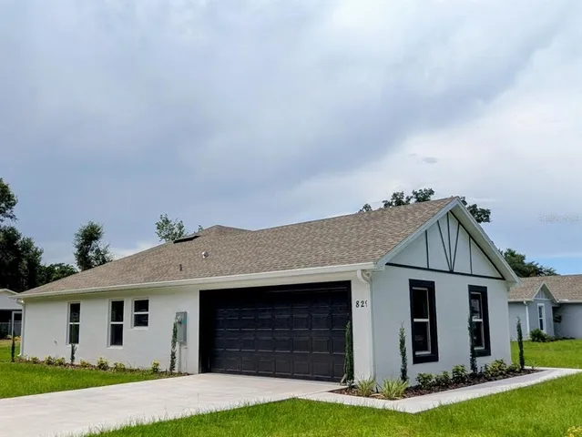a front view of a house with a yard and garage