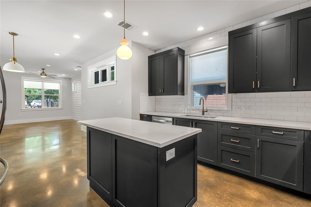 2821 Castro Street, Unit 1 Austin, TX 78702 - Photo 10 of 21 Modern kitchen featuring dark cabinetry, white subway tile backsplash, and light-toned countertops
