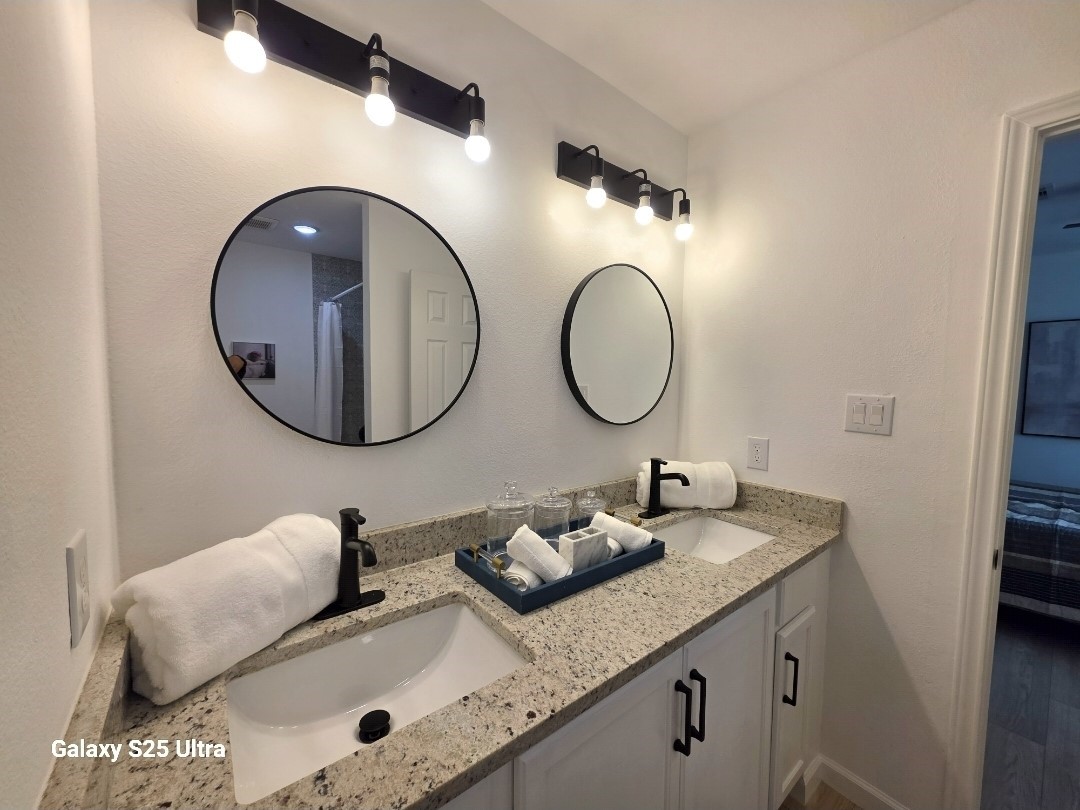 620 St Lawrence River Road Conroe, TX 77316 - Photo 9 of 21 a bathroom with a granite countertop double vanity and a mirror