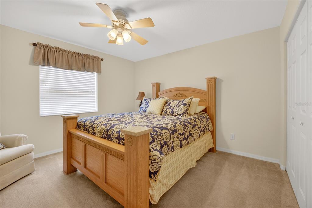6032 Southwest 103rd Loop Ocala, FL 34476 - Photo 14 of 28 a bed sitting in a bedroom next to a window