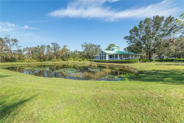 a view of a lake with houses in the back