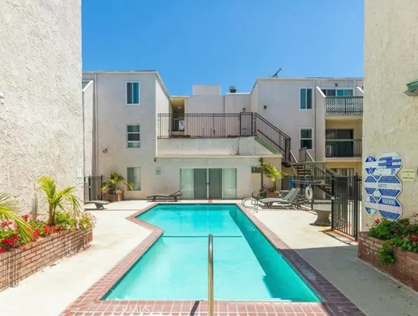 a view of a house with sitting area and swimming pool