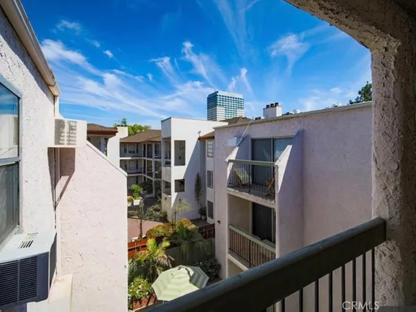 a view of roof deck with chair and wooden fence