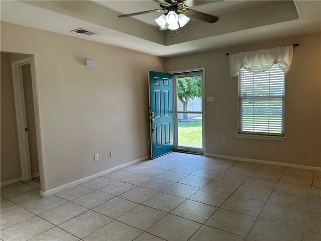 a view of an empty room with a window