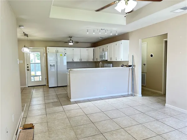 a view of a kitchen with a sink and cabinets