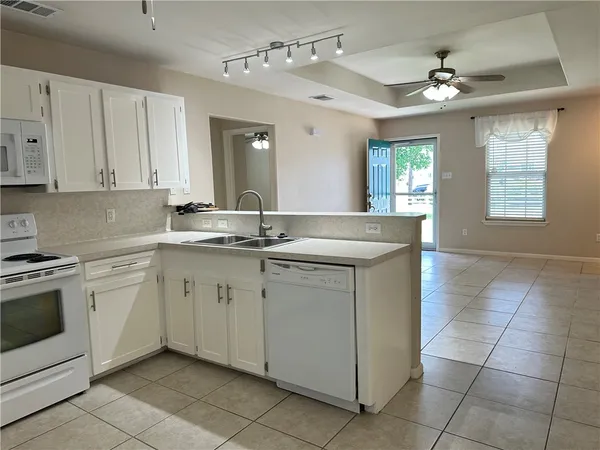 a kitchen with a sink stove and cabinets