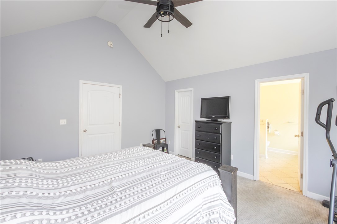 861 North Old Pendleton Road Liberty, SC 29657 - Photo 20 of 45 A comfortable bedroom features high vaulted ceilings and a ceiling fan for optimal airflow.