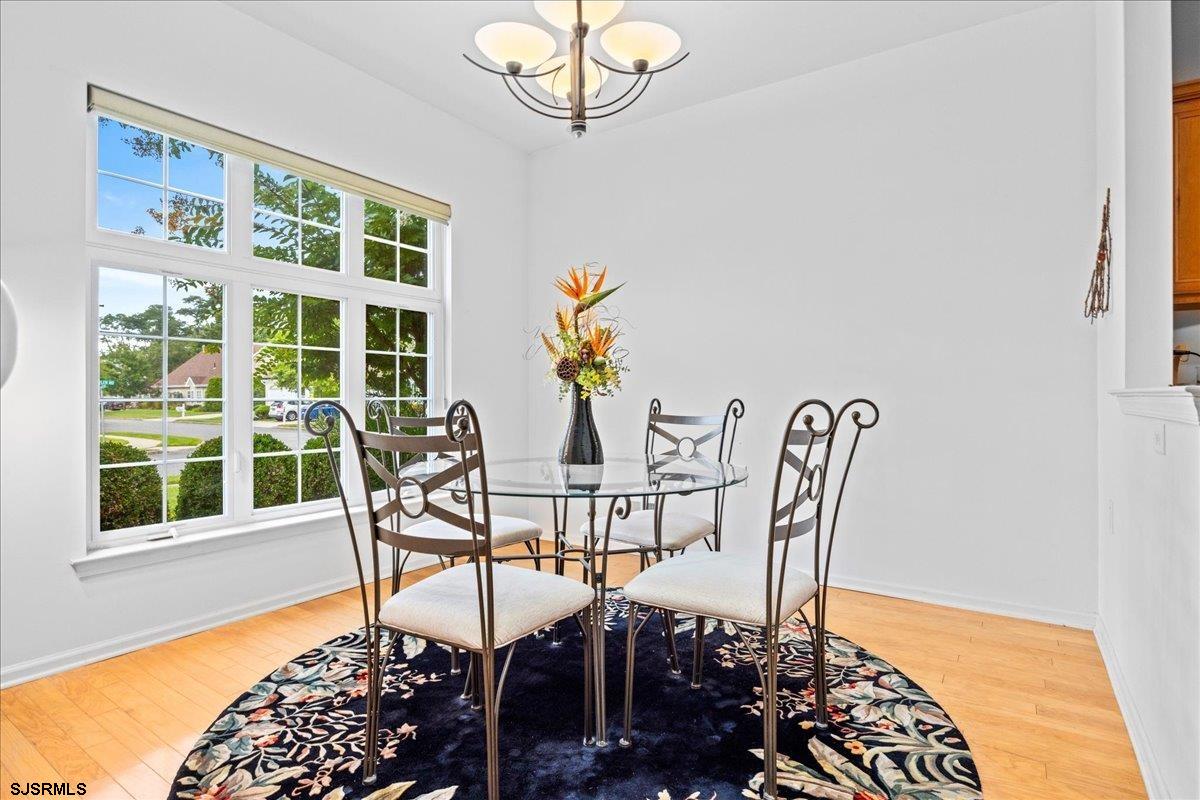 1 Butler Road Egg Harbor Township, NJ 08234 - Photo 4 of 39 a view of a dining room with furniture a chandelier and wooden floor