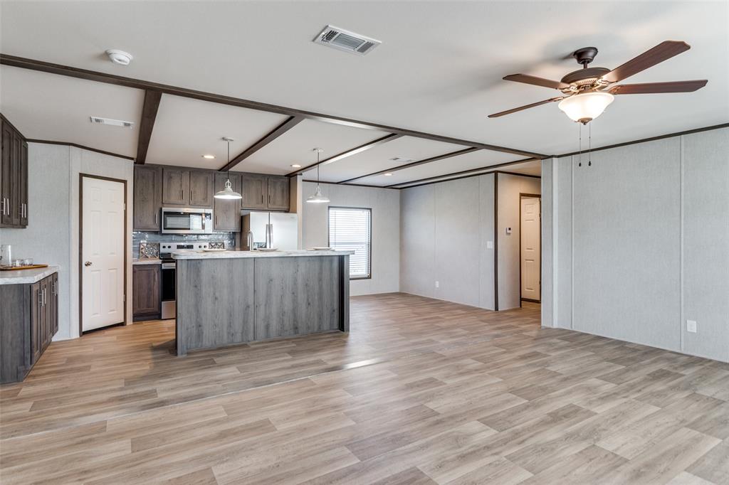 175 Cedar Drive Azle, TX 76020 - Photo 6 of 25 a view of kitchen with cabinets and wooden floor