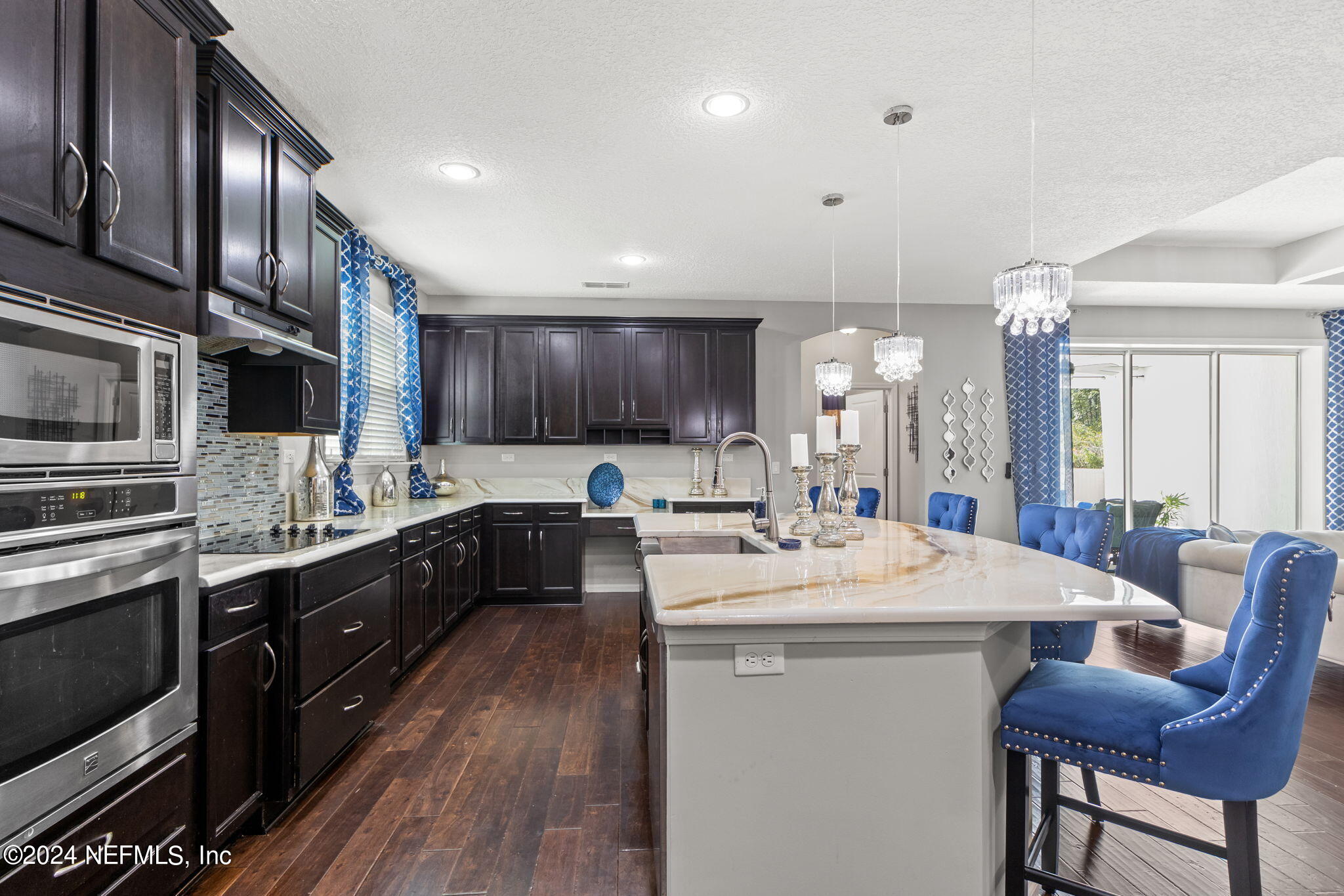 4459 Quail Hollow Road Orange Park, FL 32065 - Photo 13 of 37 a kitchen with stainless steel appliances kitchen island granite countertop a sink dishwasher a stove a refrigerator and island with wooden floor