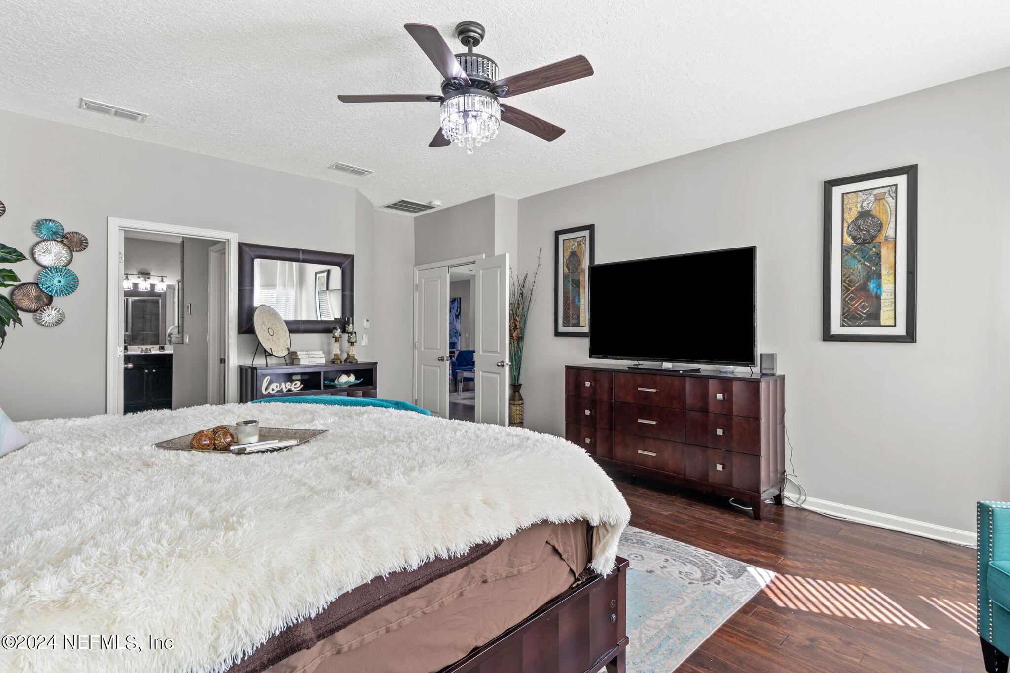 4459 Quail Hollow Road Orange Park, FL 32065 - Photo 18 of 37 a bedroom with a bed and a flat screen tv