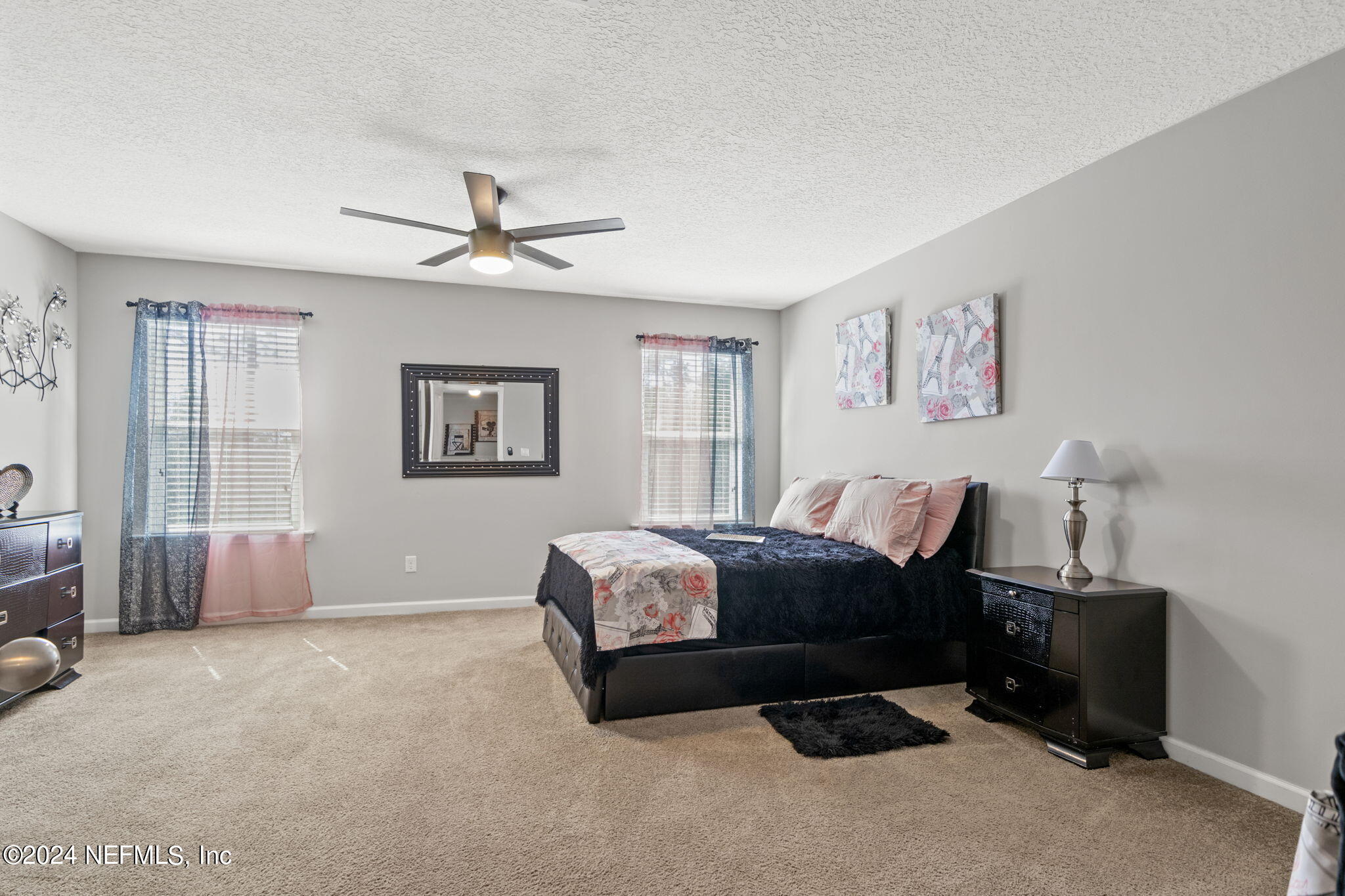 4459 Quail Hollow Road Orange Park, FL 32065 - Photo 24 of 37 a spacious bedroom with a bed a couch and a window