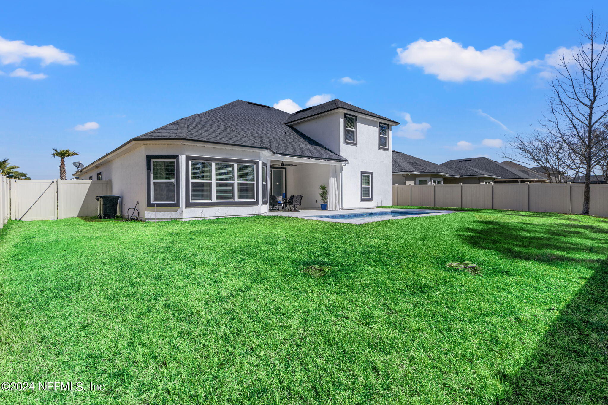 4459 Quail Hollow Road Orange Park, FL 32065 - Photo 35 of 37 a house that is sitting in the grass with large trees and plants