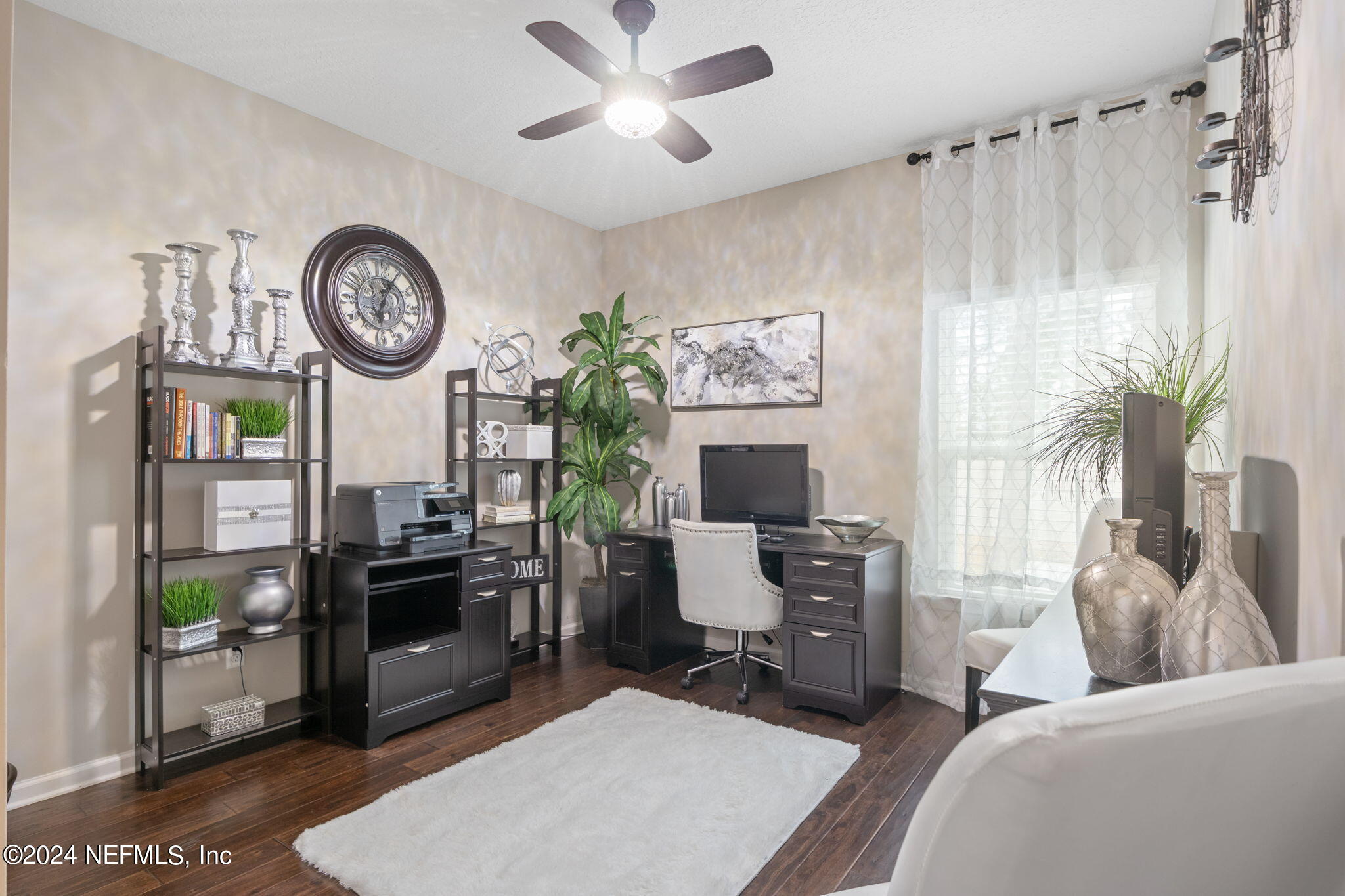 4459 Quail Hollow Road Orange Park, FL 32065 - Photo 37 of 37 a living room with furniture a clock on wall and a window