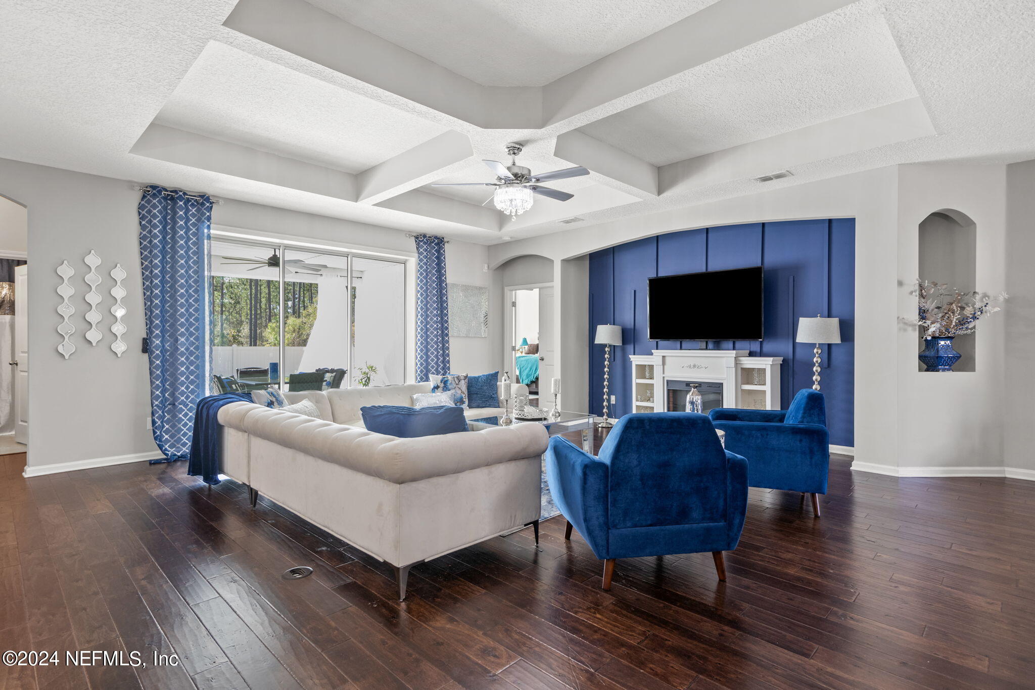 4459 Quail Hollow Road Orange Park, FL 32065 - Photo 6 of 37 a living room with furniture a flat screen tv and a fireplace