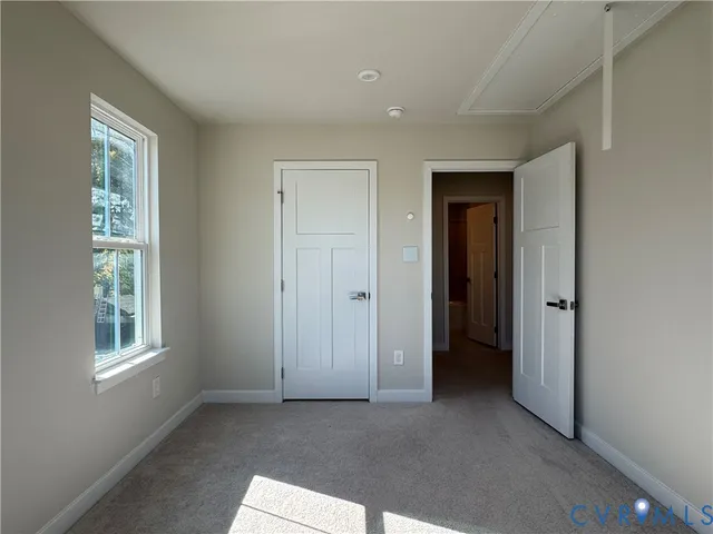 an empty room with windows and closet