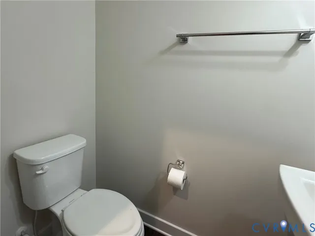 a white toilet sitting next to a shower