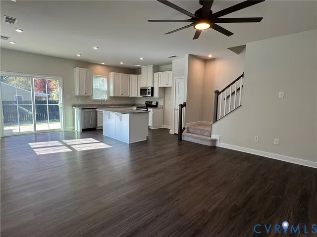 a view of kitchen with sink and refrigerator