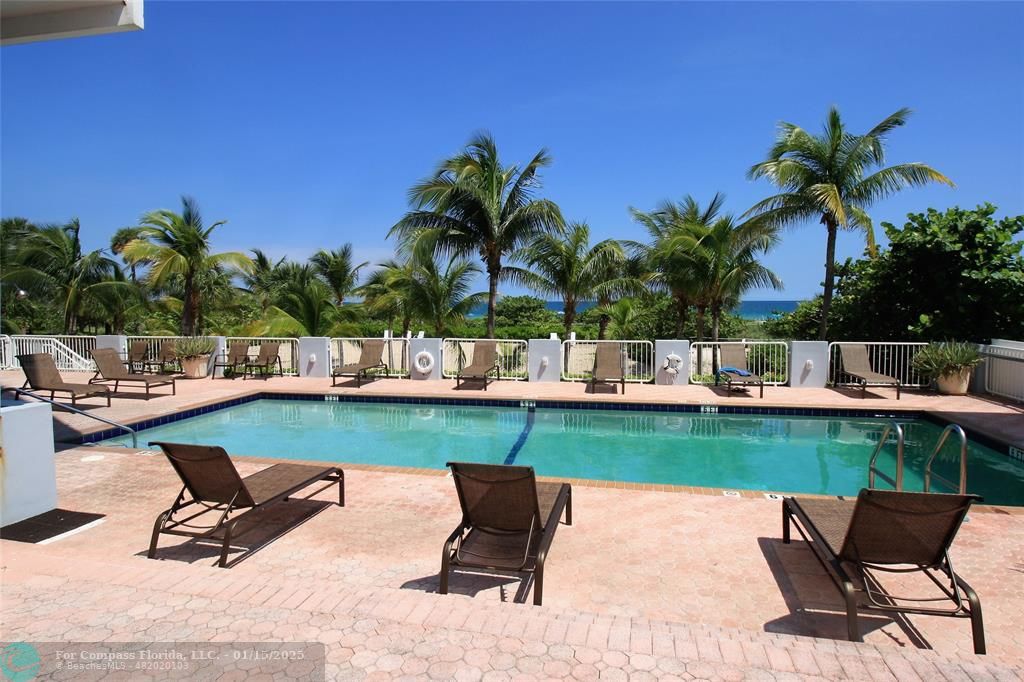 9341 Collins Avenue, Unit 1003 Surfside, FL 33154 - Photo 1 of 24 a view of a swimming pool and lounge chair