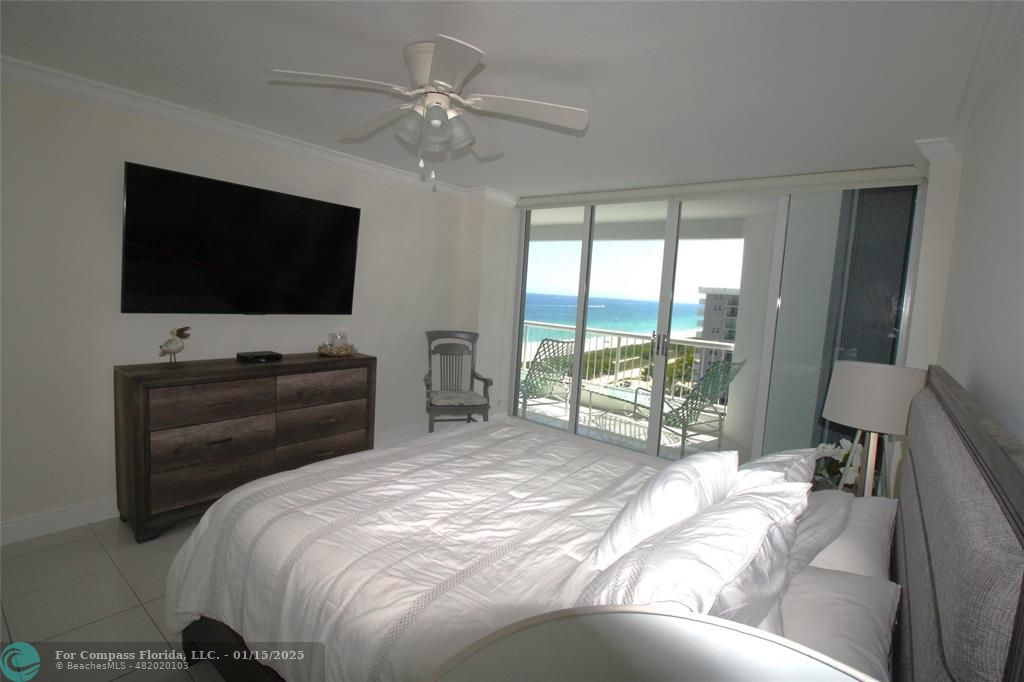 9341 Collins Avenue, Unit 1003 Surfside, FL 33154 - Photo 11 of 24 a bed room with a bed and a television