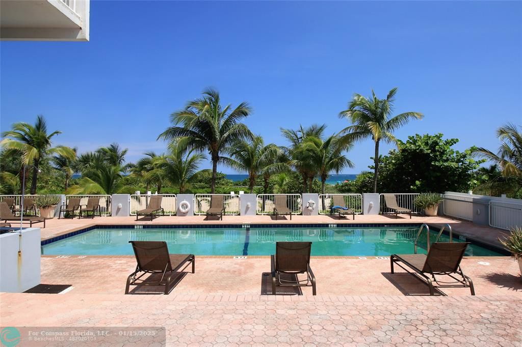 9341 Collins Avenue, Unit 1003 Surfside, FL 33154 - Photo 20 of 24 a swimming pool with outdoor seating and a potted plants