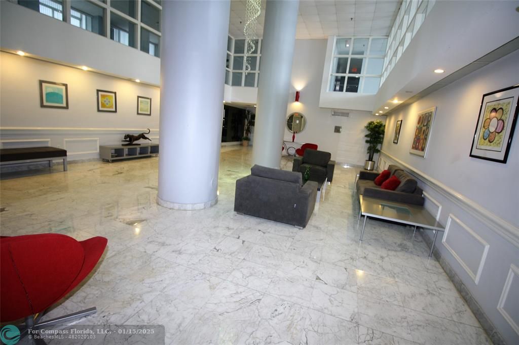 9341 Collins Avenue, Unit 1003 Surfside, FL 33154 - Photo 24 of 24 a living room with furniture and a couch