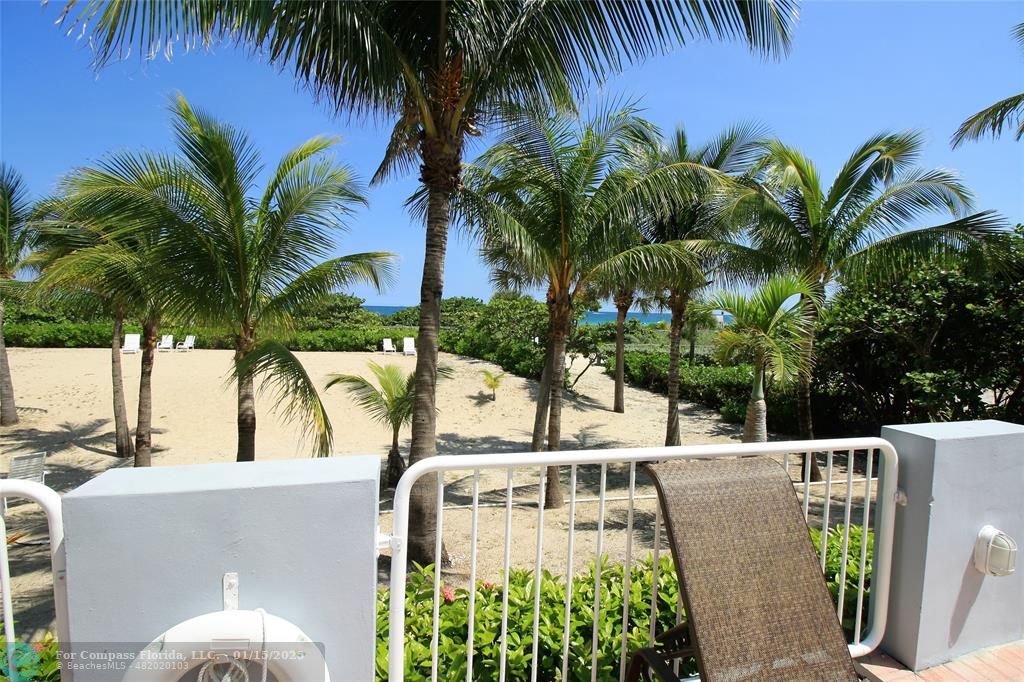 9341 Collins Avenue, Unit 1003 Surfside, FL 33154 - Photo 5 of 24 a view of a backyard with a fountain and a palm tree