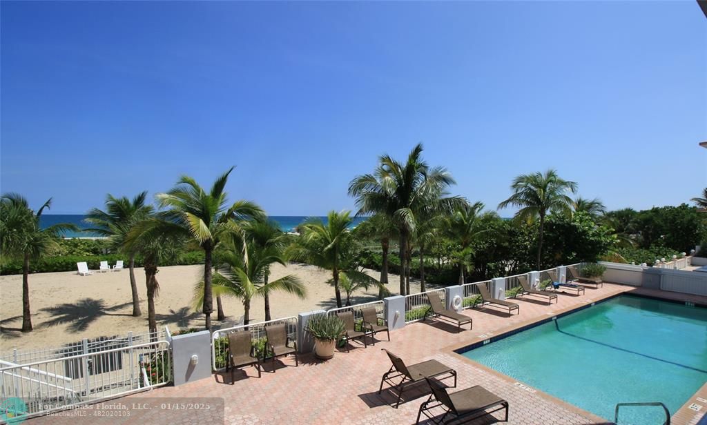 9341 Collins Avenue, Unit 1003 Surfside, FL 33154 - Photo 8 of 24 a view of a swimming pool with lounge chairs