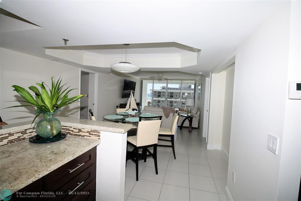 9341 Collins Avenue, Unit 1003 Surfside, FL 33154 - Photo 9 of 24 a dining room with furniture and potted plants