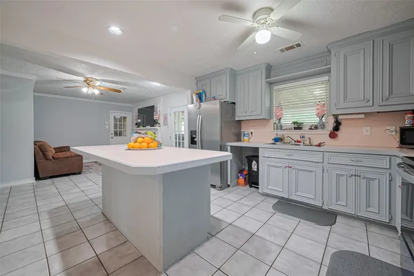 a utility room with cabinets and washer dryer