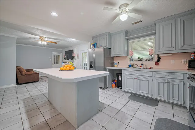 a utility room with cabinets and washer dryer