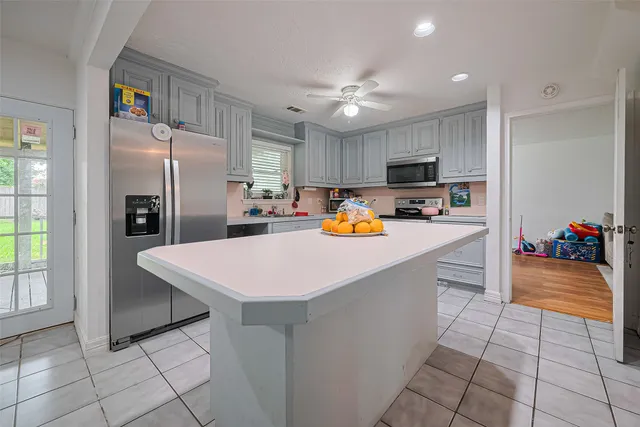a kitchen with stainless steel appliances a refrigerator sink and microwave