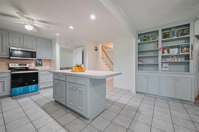 a kitchen with stainless steel appliances a stove and more cabinets