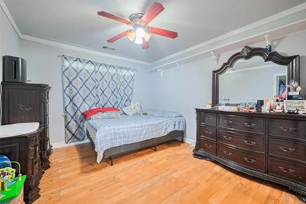 a bedroom with a bed and dresser
