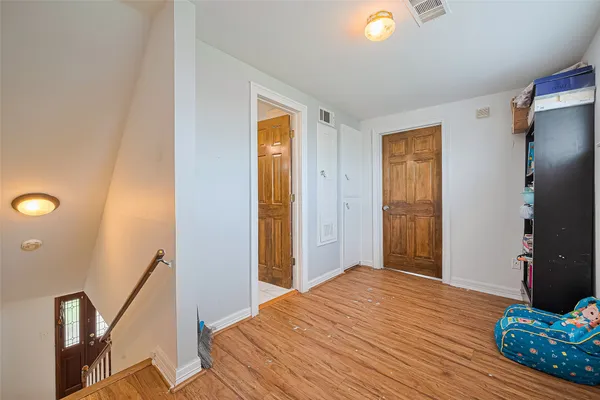 a bedroom with a bed and a potted plant