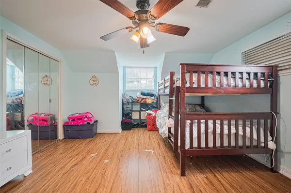 a bedroom with furniture and wooden floor