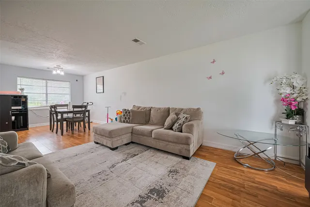 a living room with furniture and flowers