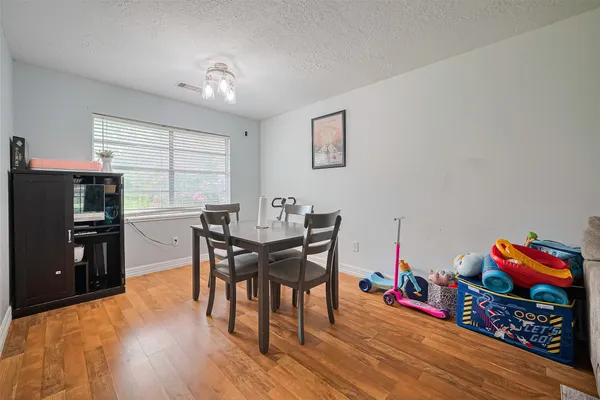 a view of a dining room with furniture and wooden floor