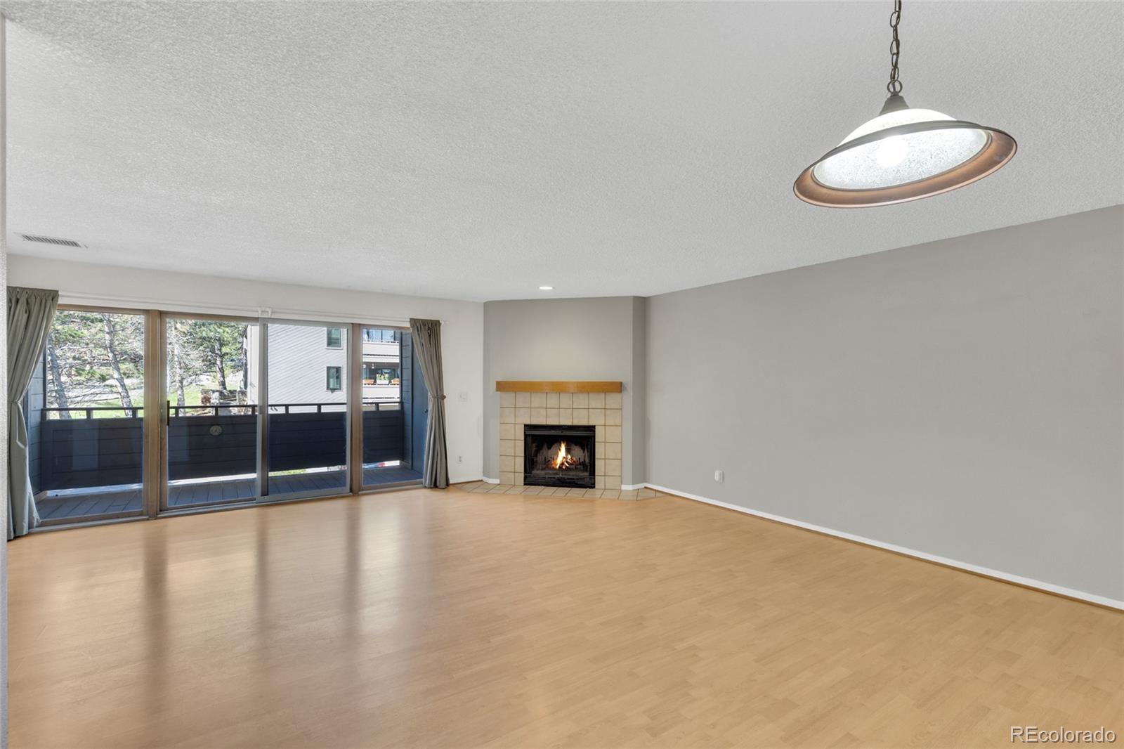 23537 Genesee Village Road Golden, CO 80401 - Photo 11 of 37 an empty room with fireplace and windows
